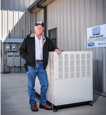 Washington Volunteer Fire Department chief Clyde Miller, above, with the 48 kilowatt emergency generator purchased with a grant from LCRA and Bluebonnet. The generator's 500-gallon propane tank could keep it running for up to a week before a refill.
