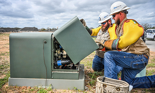 Bluebonnet crews open a pad-mounted transformer box for a conversion.