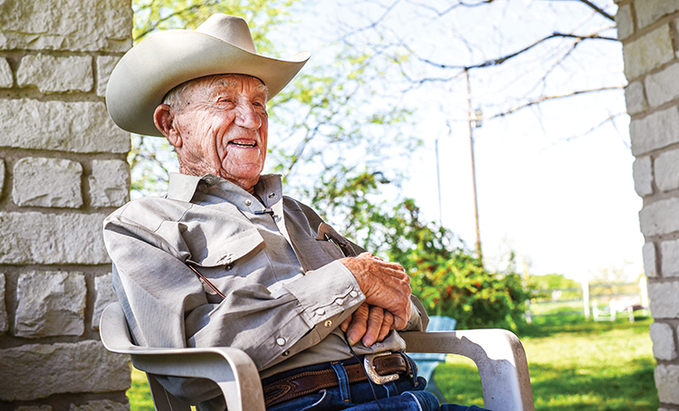 Arthur Goertz sits on the front porch of his neatly kept country home, looking out over the rolling pastureland and Post Oak savannahs of southwestern Bastrop County, his eyes squinting a bit under the brim of his Resistol.