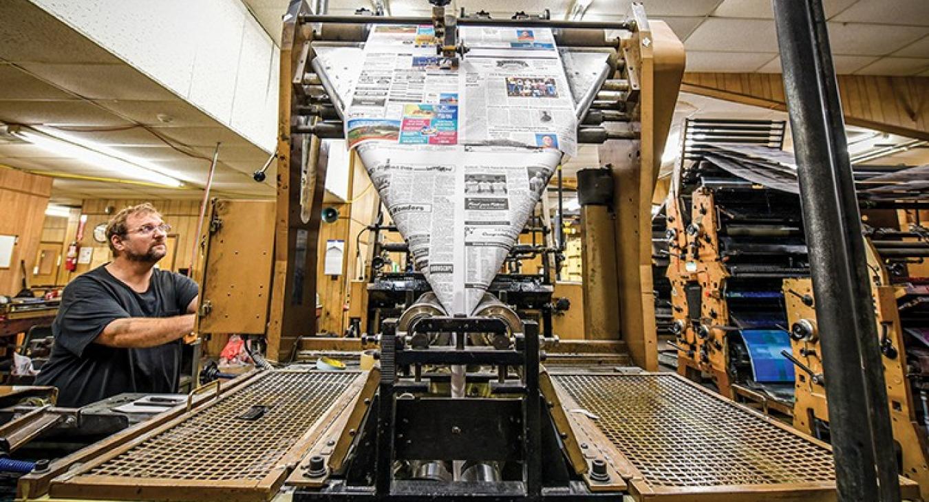 Printing supervisor Clifton Green, who has been at the Brenham Banner Press for more than 30 year, checks the calibration of the printing press.