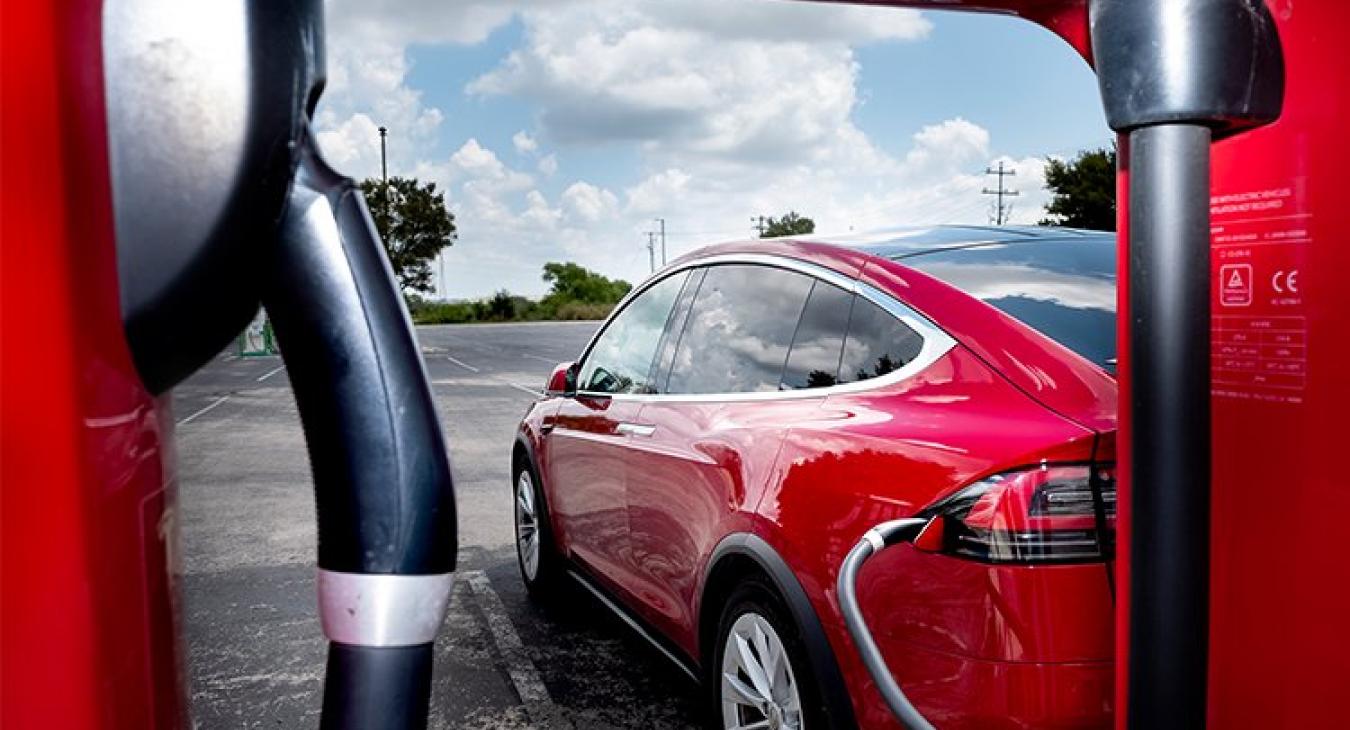 A Tesla charges at one of a dozen Tesla Supercharger stations at the San Marcos Premium Outlet mall along Interstate 35. The area also has EVgo and ChargePoint stations, which are both DC fast chargers for other types of electric vehicles. (Laura Skelding photo)